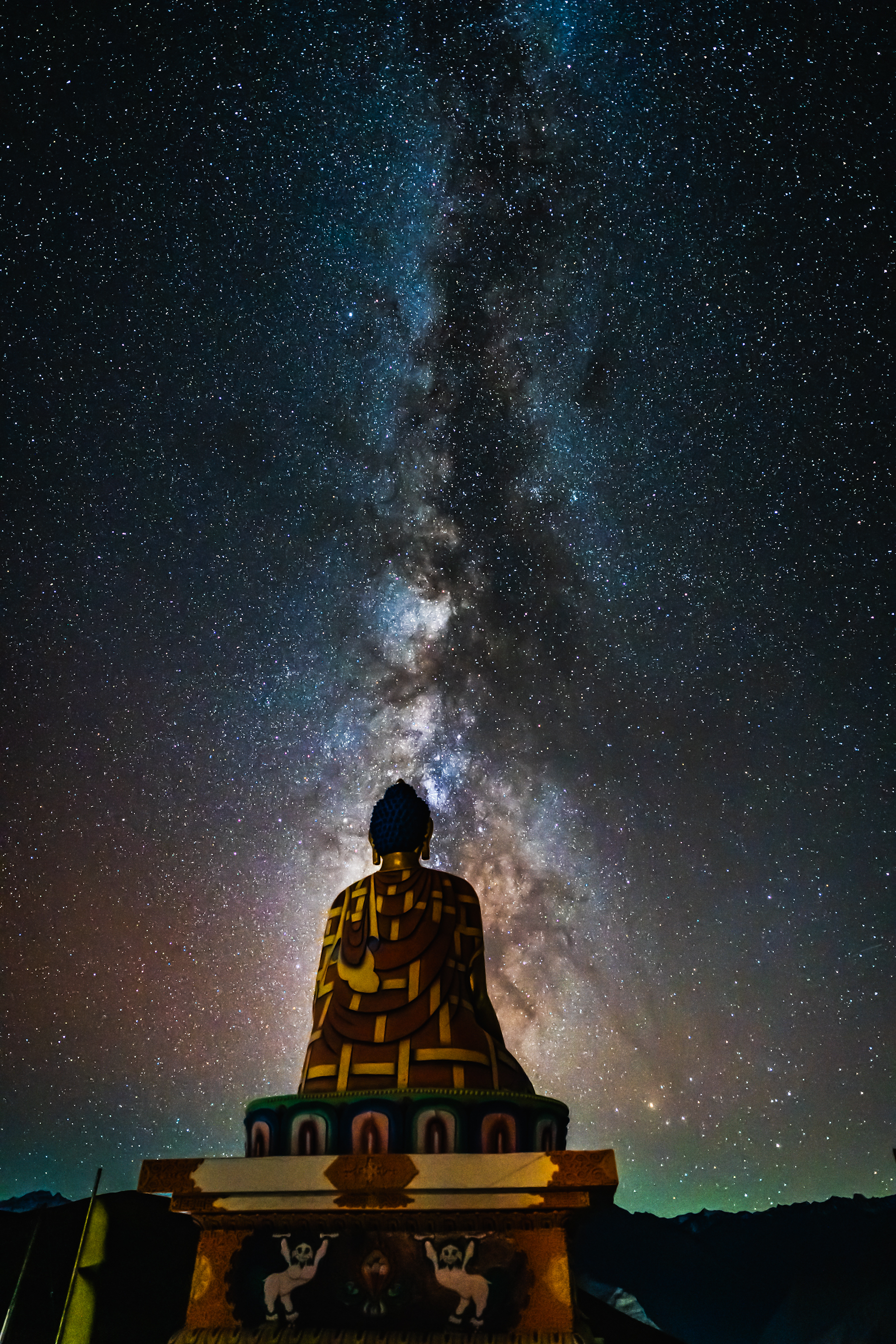Milky way galaxy strip in a night sky behind a budha statue in Spiti valley, Himachal Pradesh, India