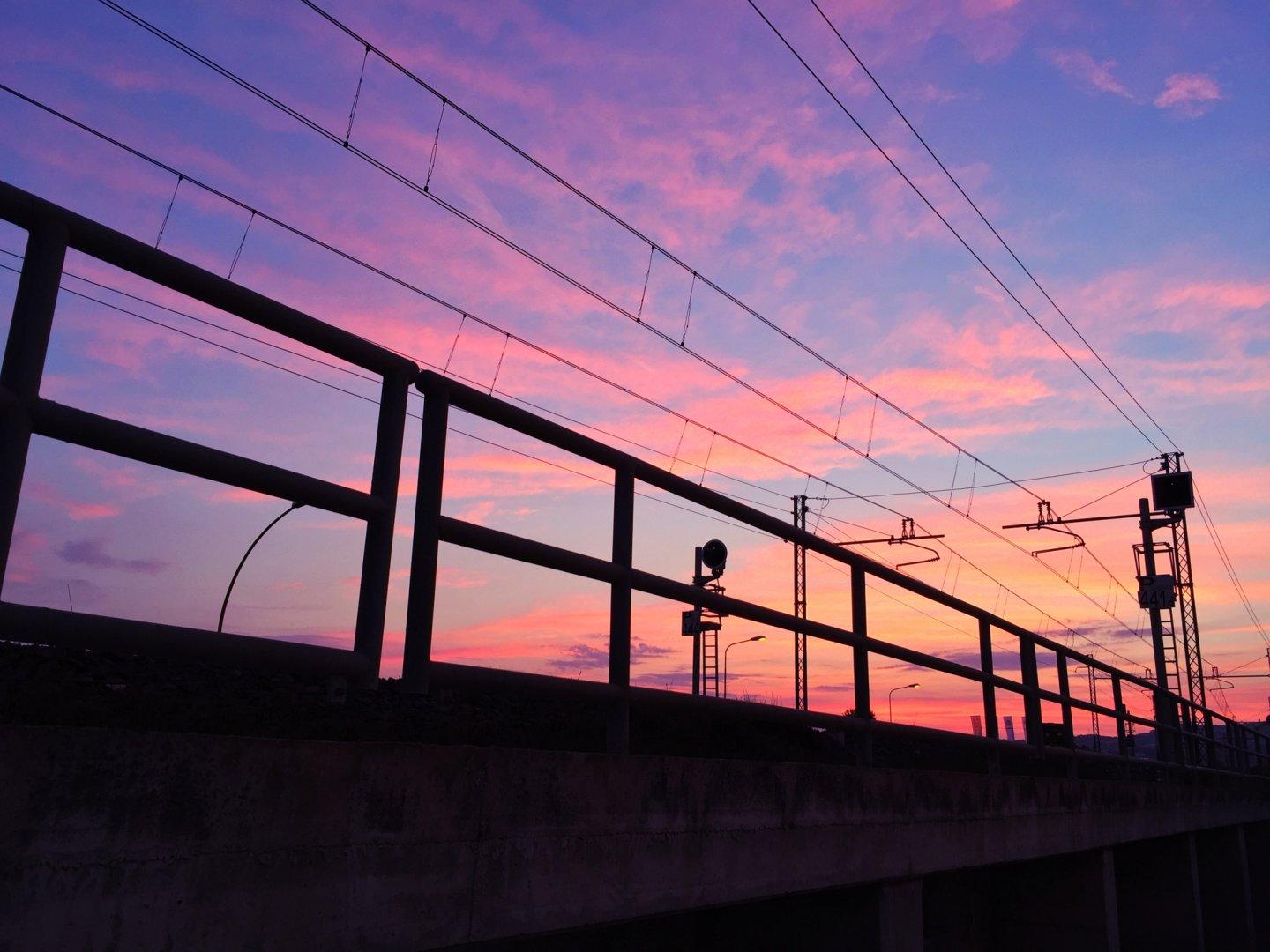 Sunset with train tracks in foreground.